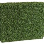 Artificial boxwood hedge panel with dense two-tone green foliage, photographed at an angle against a white background