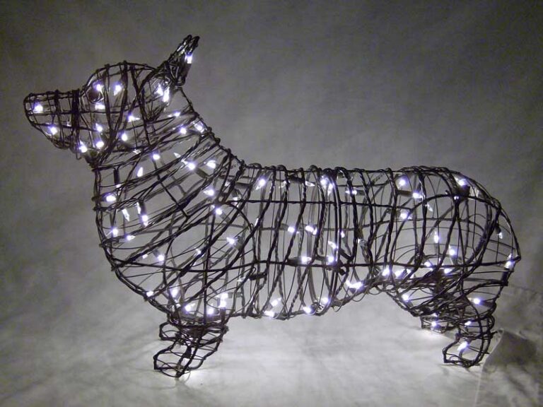 Corgi topiary frame in dark wire wrapped in lit white mini lights, glowing against a grey backdrop