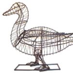 Bare wire frame sculpture of a duck with a curved neck and folded wings, on a rectangular base, studio photo.