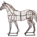 Wire-frame horse topiary, standing in profile on a plain white background