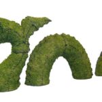 Moss-covered topiary shaped like a serpentine sea monster with three humps and a raised head.