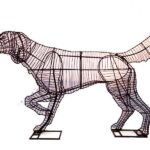 Wire-frame pointer dog topiary, standing in profile with one front leg raised