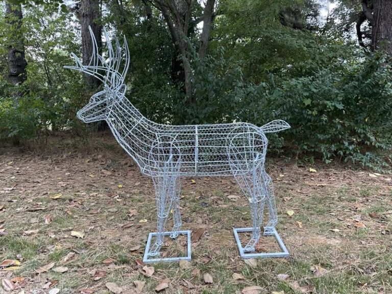 Deer topiary frame wrapped in wire mesh ready for planting, on leaf-covered ground
