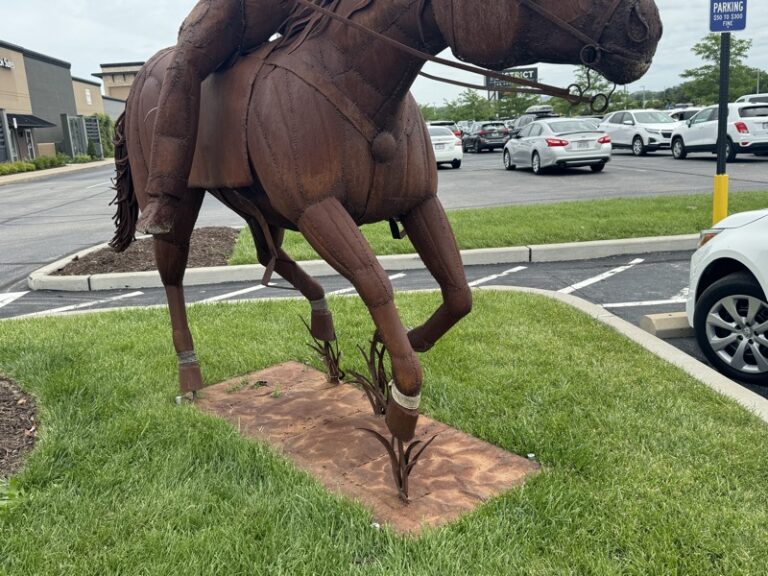 Close-up of the sculpture's rear legs and metal mounting base
