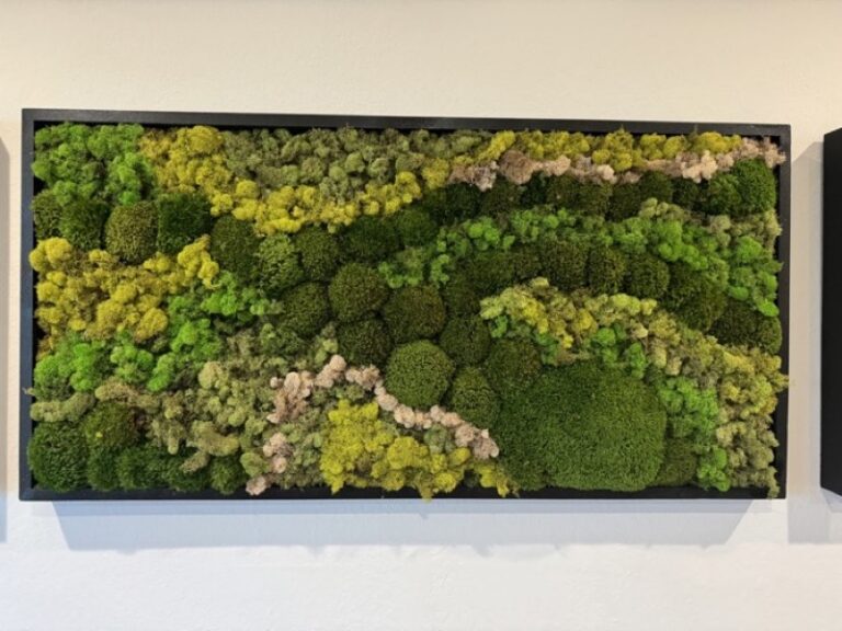 Rectangular wall art framed in black wood, filled with green and gold-toned moss in a mottled pattern.