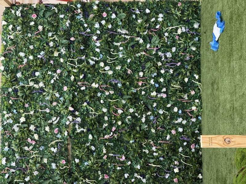 Preserved green wall with floral accents at the exhibition
