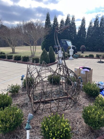 Swan topiary frame after stripping and galvanized metal spray, close-up angle