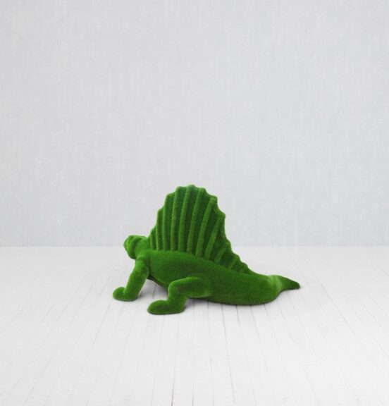 Green moss-covered dinosaur sculpture standing on the floor