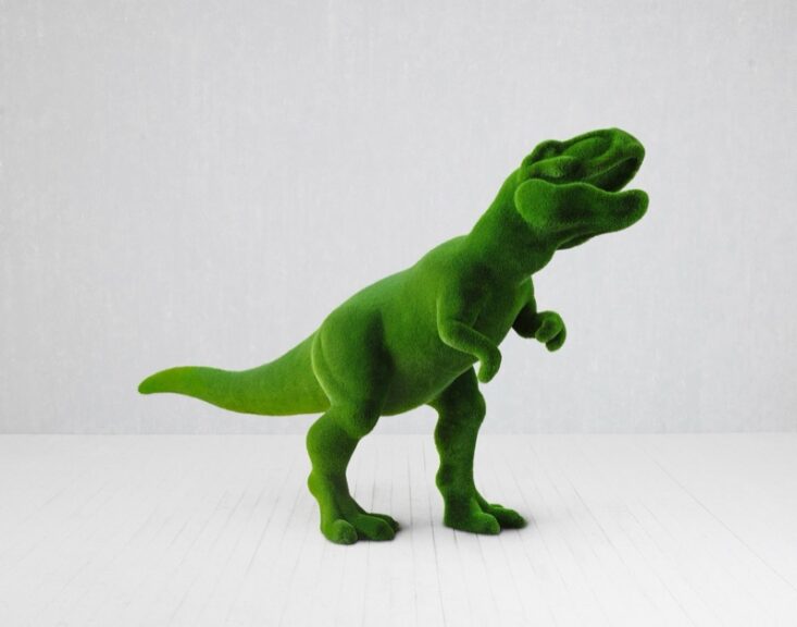 Green turf-textured T-Rex sculpture on a plain white background