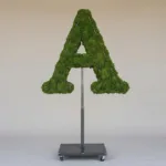 Monogram letter A topiary in Roman style, packed with green moss, on an adjustable stand