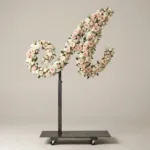 Monogram letter A topiary in script style, covered in pink and white roses