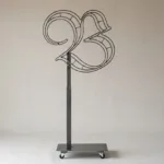 Monogram letter B topiary frame in Custom style, bare galvanized steel on an adjustable stand