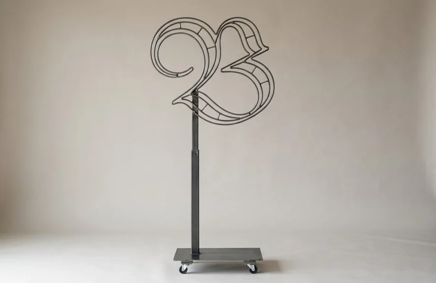 Monogram letter B topiary frame in Custom style, bare galvanized steel on an adjustable stand