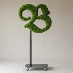 Monogram letter B topiary in Custom style, packed with green moss, on an adjustable stand