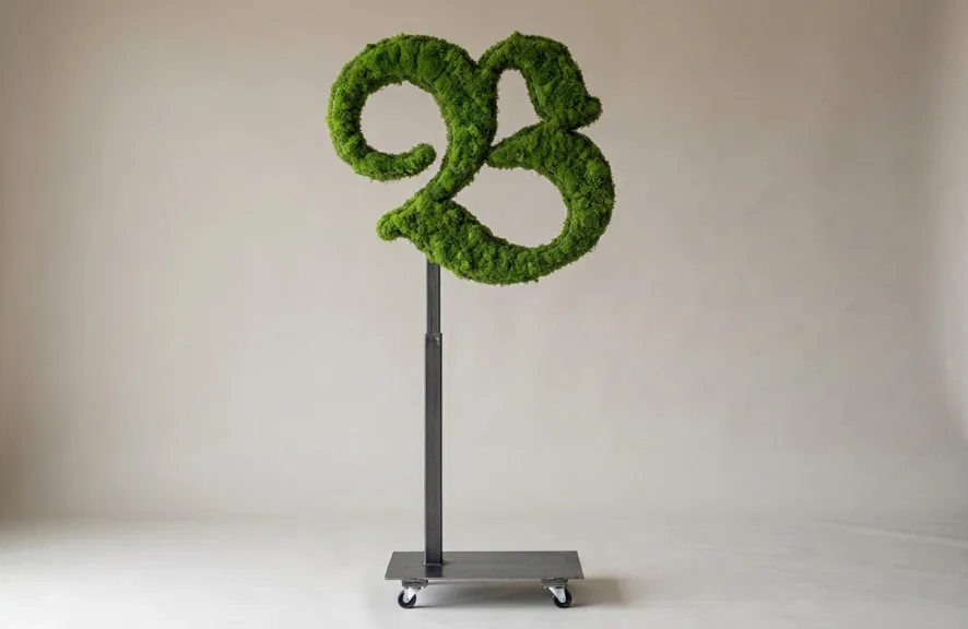 Monogram letter B topiary in Custom style, packed with green moss, on an adjustable stand