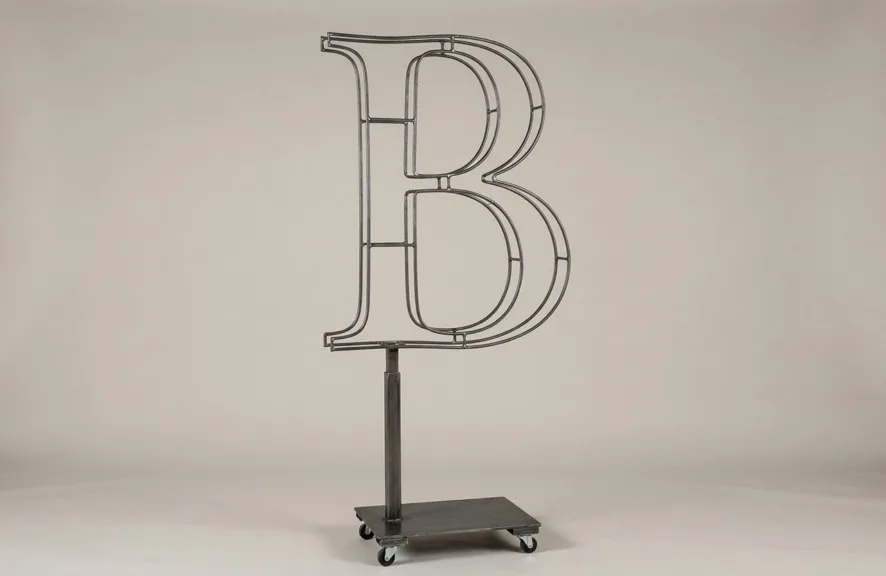 Monogram letter B topiary frame in Roman style, bare galvanized steel on an adjustable stand
