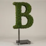 Monogram letter B topiary in Roman style, packed with green moss, on an adjustable stand