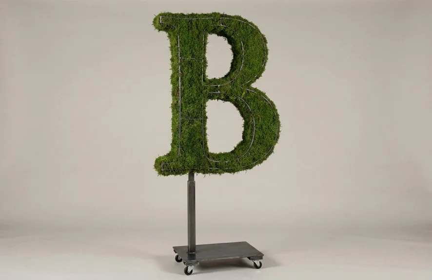 Monogram letter B topiary in Roman style, packed with green moss, on an adjustable stand