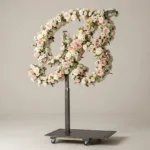 Monogram letter B topiary in script style, covered in pink and white roses