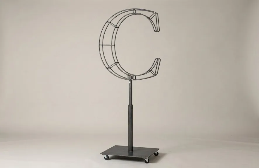 Monogram letter C topiary frame in Cinzel style, bare galvanized steel on an adjustable stand