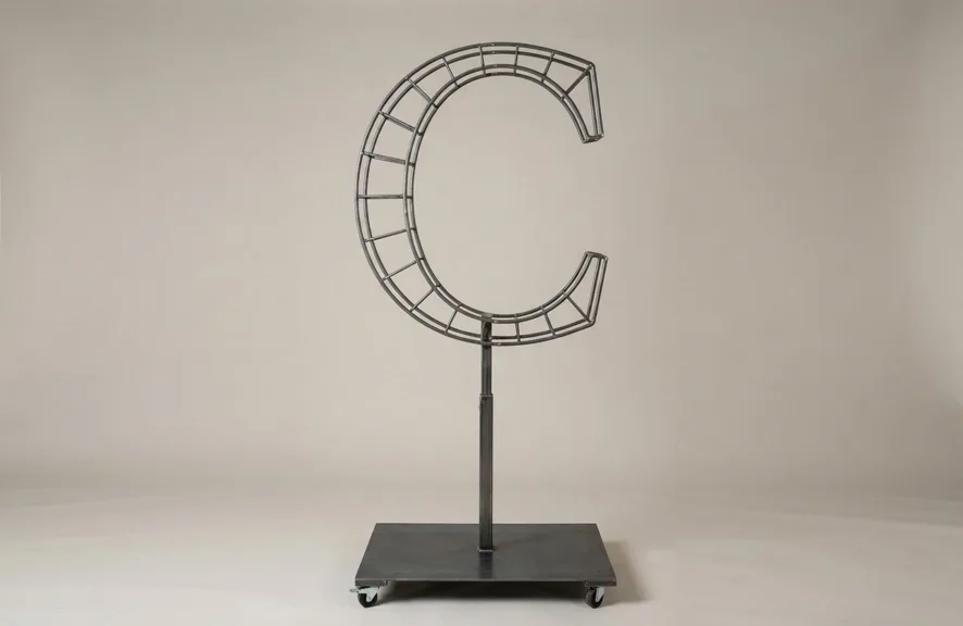 Monogram letter C topiary frame in Roman style, bare galvanized steel on an adjustable stand