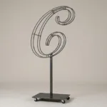 Monogram letter C topiary frame in Script style, bare galvanized steel on an adjustable stand