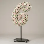 Monogram letter C topiary in script style, covered in pink and white roses