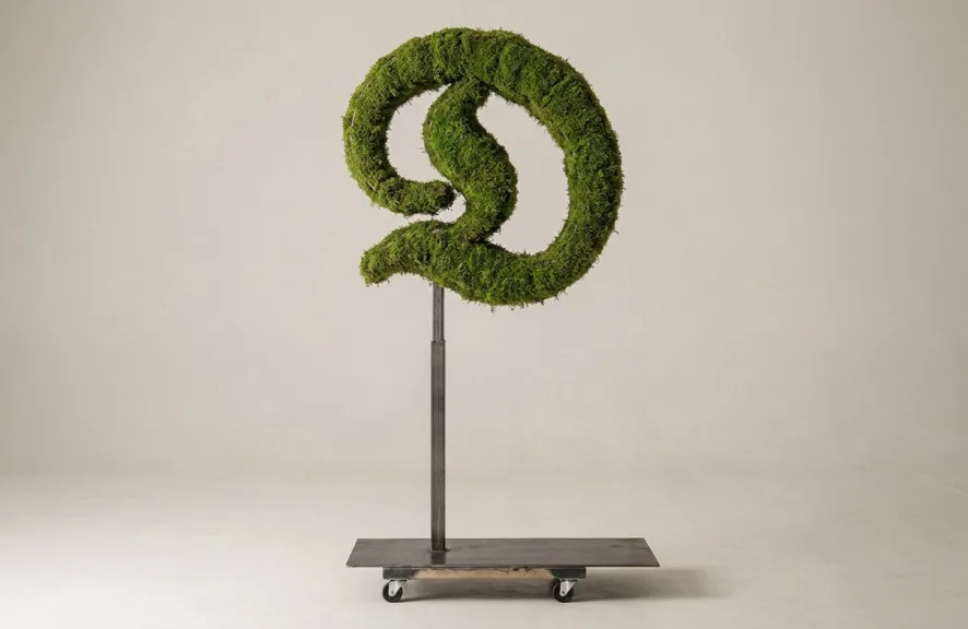 Monogram letter D topiary in Custom style, packed with green moss, on an adjustable stand