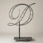 Monogram letter D topiary frame in Script style, bare galvanized steel on an adjustable stand