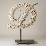 Monogram letter D topiary in script style, covered in pink and white roses
