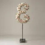 Monogram letter E topiary in script style, covered in pink and white roses