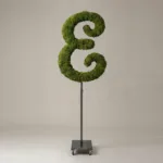 Monogram letter E topiary in Script style, packed with green moss, on an adjustable stand