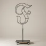 Monogram letter F topiary frame in Custom style, bare galvanized steel on an adjustable stand