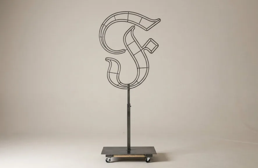 Monogram letter F topiary frame in Custom style, bare galvanized steel on an adjustable stand