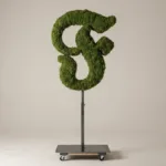 Monogram letter F topiary in Custom style, packed with green moss, on an adjustable stand