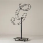 Monogram letter G topiary frame in Script style, bare galvanized steel on an adjustable stand