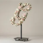Monogram letter G topiary in script style, covered in pink and white roses