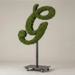 Monogram letter G topiary in Script style, packed with green moss, on an adjustable stand