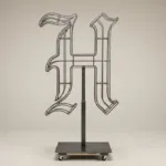 Monogram letter H topiary frame in Custom style, bare galvanized steel on an adjustable stand