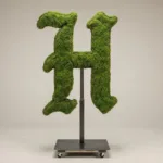 Monogram letter H topiary in Custom style, packed with green moss, on an adjustable stand