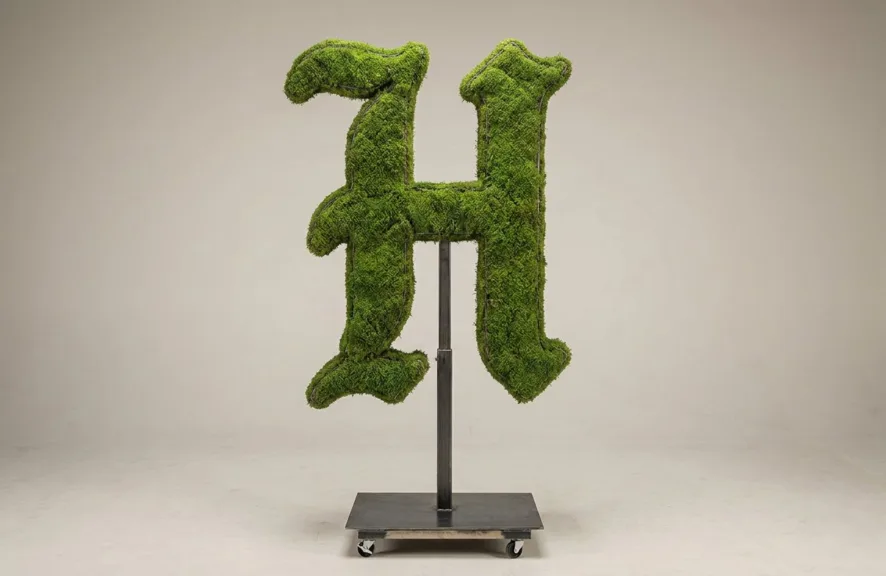 Monogram letter H topiary in Custom style, packed with green moss, on an adjustable stand