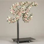 Monogram letter H topiary in script style, covered in pink and white roses