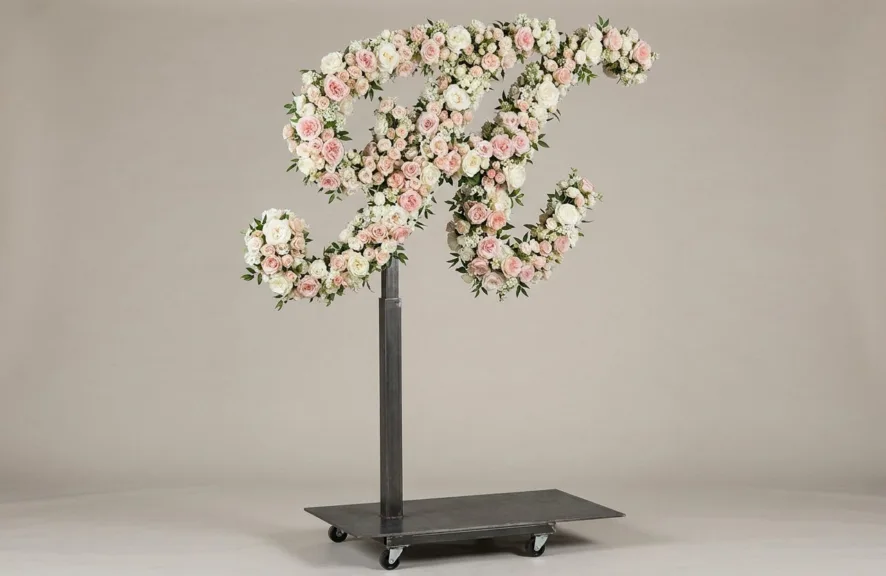 Monogram letter H topiary in script style, covered in pink and white roses