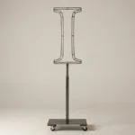 Monogram letter I topiary frame in Cinzel style, bare galvanized steel on an adjustable stand