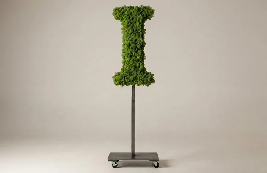 Monogram letter I topiary in Cinzel style, packed with green moss, on an adjustable stand