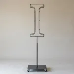 Monogram letter I topiary frame in Roman style, bare galvanized steel on an adjustable stand
