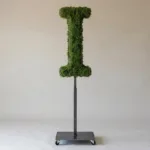 Monogram letter I topiary in Roman style, packed with green moss, on an adjustable stand