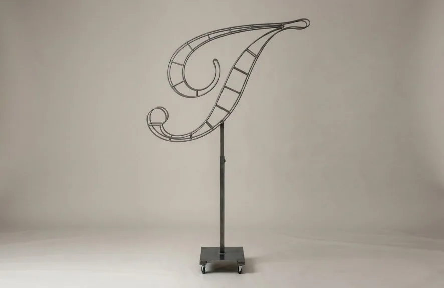 Monogram letter I topiary frame in Script style, bare galvanized steel on an adjustable stand