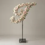 Monogram letter I topiary in script style, covered in pink and white roses