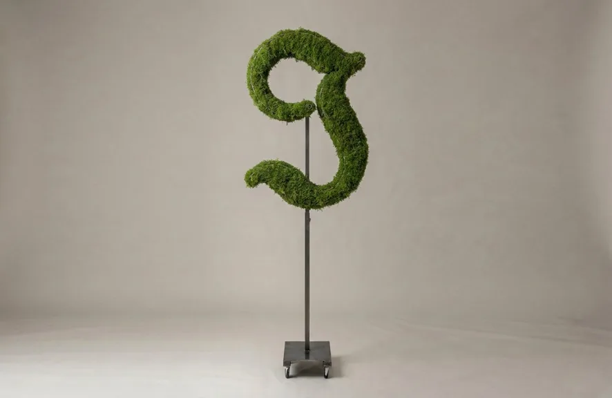 Monogram letter J topiary in Custom style, packed with green moss, on an adjustable stand
